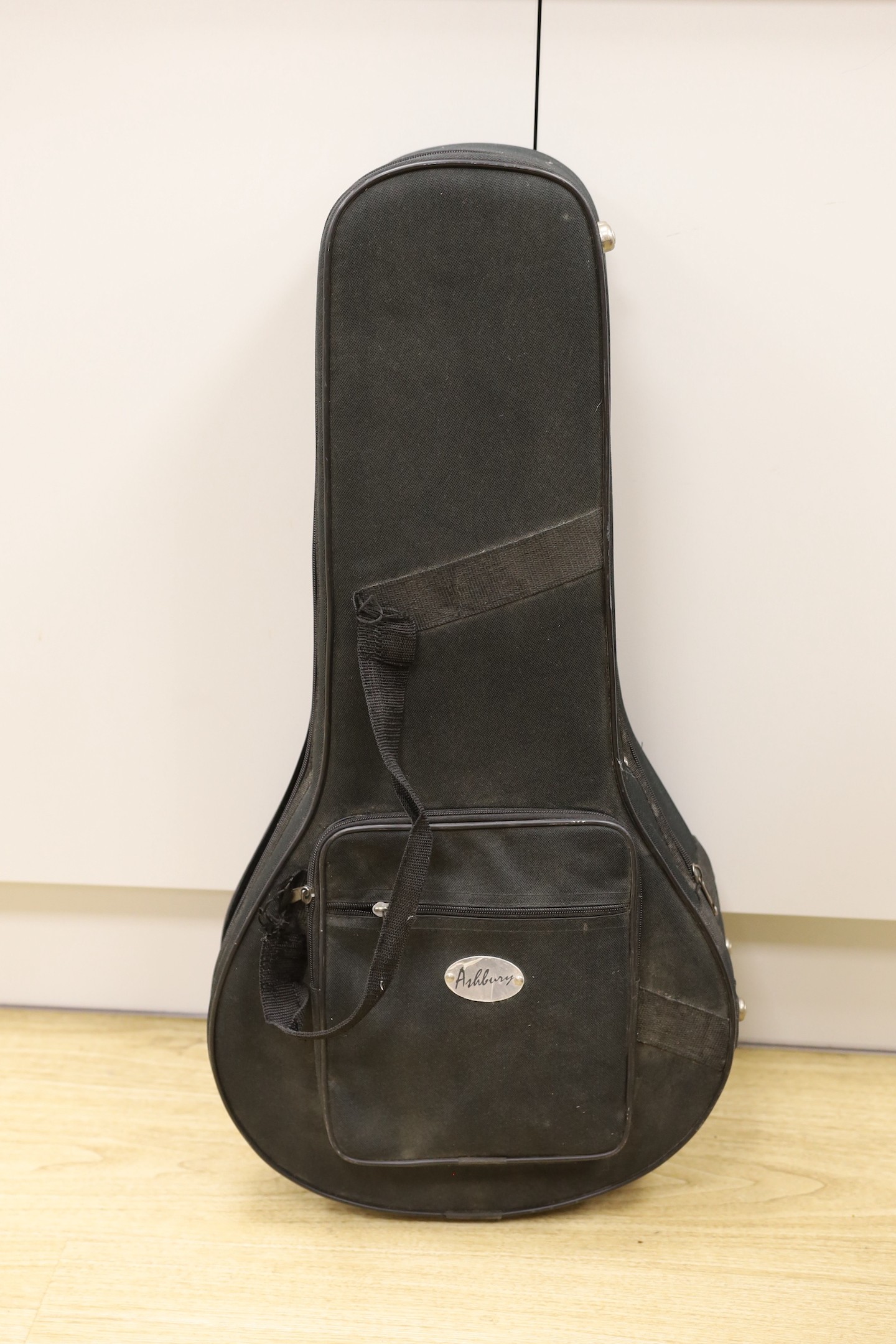 An Ashbury mandolin ‘Resonator’ with fitted, padded case, mandolin 69 cms high.